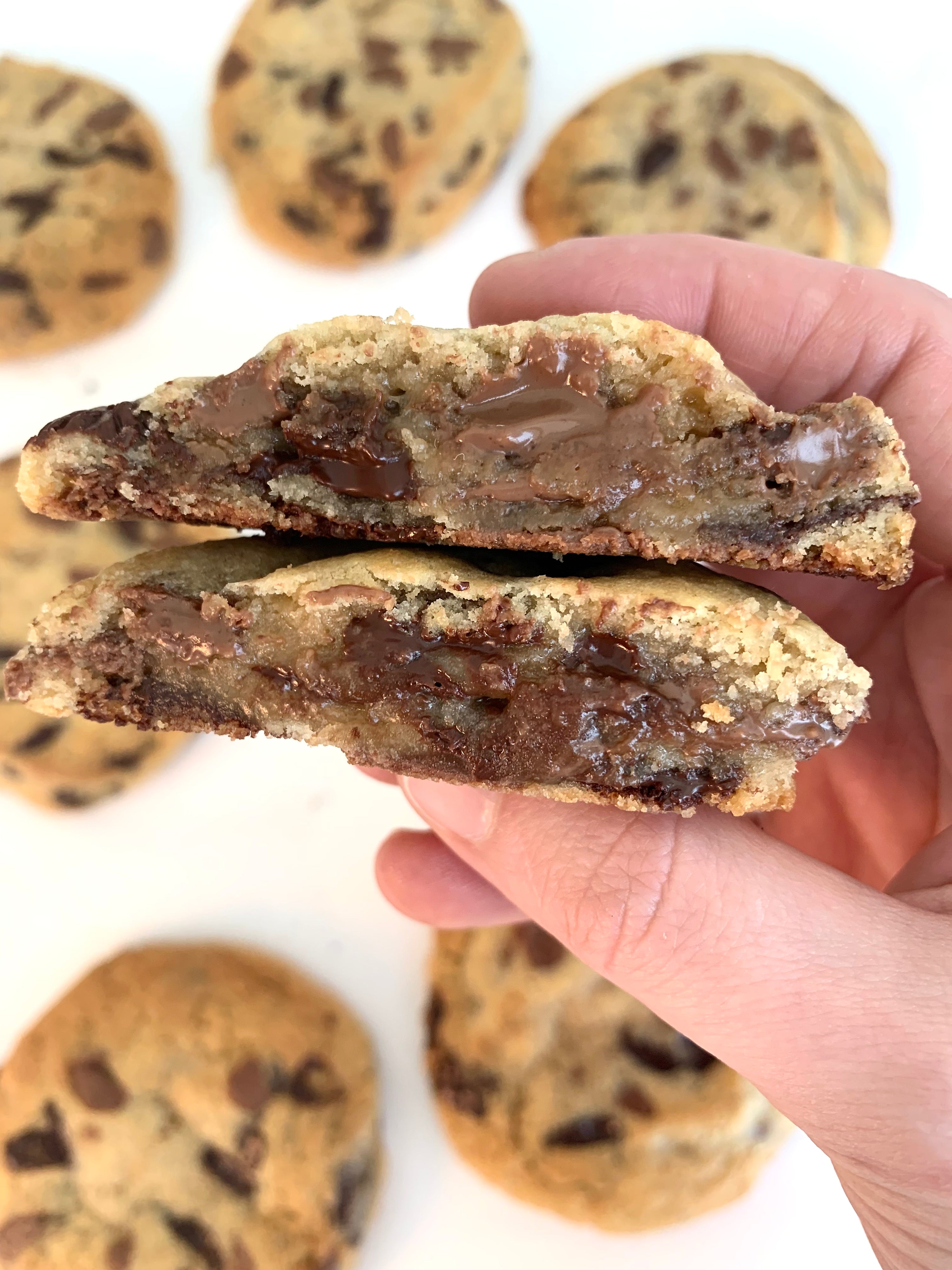 'Freshly baked chocolate chunk cookies on parchment paper cross section
